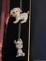 Brooch and pendant necklace side by side showing scale and sparkle