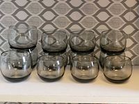 Front view of all twelve smoked glass roly poly tumblers