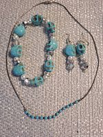 Entire set laid out: bracelet, earrings, necklace