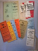 Group shot of all ten TH&B Railway timetables showing covers, colours and titles