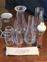 Group view of lamp, five chimneys, metal stand, Rayo wick