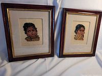 Both framed petite point portraits side by side