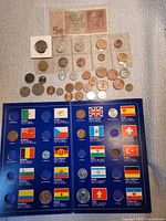 Overall view of coins, two banknotes and open folder
