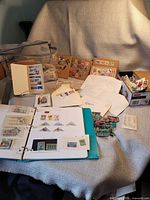 Full lot showing album, tote, envelopes, box and stamp groupings