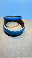 Two turquoise enamel brass bangles stacked