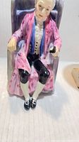 Front view of Royal Doulton Darby figurine seated in chair