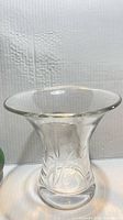 Full view of clear glass vase showing flared rim and etched design