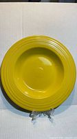 Front view of yellow Fiestaware luncheon plate