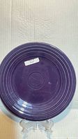 Front of plum Fiestaware 9-inch plate on stand