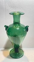 Full front view of emerald green glass vase showing overall form