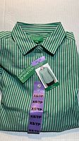 Folded green and white striped Benetton dress shirt with tags visible