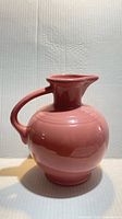 Front view of rose pink spherical Fiesta pitcher
