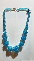 Full view of necklace showing clustered bead balls and clasp