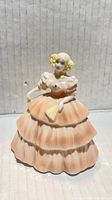 Front view of Coalport bone china figurine showing peach dress and fan