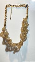 Full view of twisted gold mesh necklace with curb chain and extender