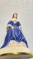 Front view of hand painted Wedgeport figurine showing dress and base