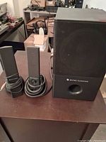 Full system view: subwoofer and two satellites with cables