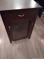 Front view showing drawer, glass door and overall style