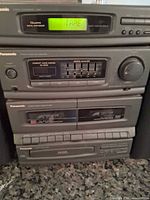 Front view of stacked Panasonic tuner, amplifier, cassette deck, CD player