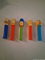 Five Simpsons PEZ dispensers standing upright