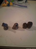All three owl figurines lined up on table