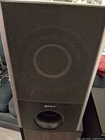 Front view showing grille, port, Sony logo