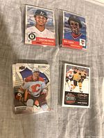 Four sample cards: Pache Topps, Carew Topps, Tkachuk UD Allure, Thornton card