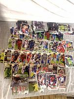 Wide view of approximately 150 soccer trading cards spread on table