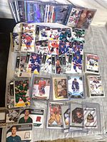 Overview of assorted Upper Deck hockey cards spread out, showing base and memorabilia cards
