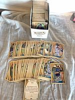 Open card storage box with visible stack of 2021 Gypsy Queen cards and spread of additional cards in front