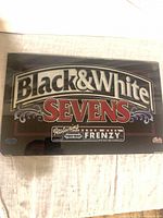 Front view of Bally Black & White Sevens backglass showing full graphics