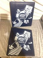 Front view of both navy binders with white goalie graphic