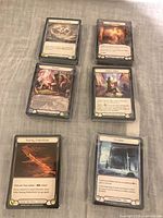 Six visible wrapped stacks of Flesh and Blood token cards