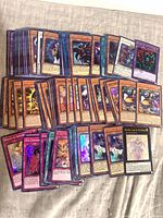Overview of approximately 100 Yu-Gi-Oh holo/foil cards spread out