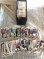 Assorted Bowman 2023 baseball cards spread out with storage box