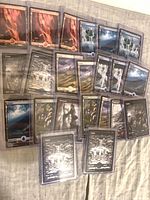 Grouped view of full-art MTG basic land cards in toploaders