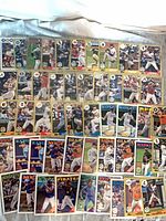 Full lot layout showing roughly 50 1987-design Topps baseball cards in sleeves