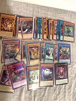 Group of Yu-Gi-Oh! cards spread out, holo and common visible