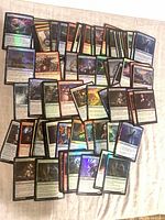 Overhead view of roughly 100 foil MTG cards spread out