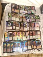 Overview of 50 foil retro-frame Magic: The Gathering cards spread out on surface