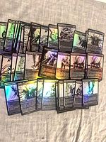 Spread of approximately 40 foil Phyrexia cards