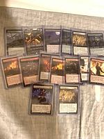 Front view of 15 sleeved extended-art cards