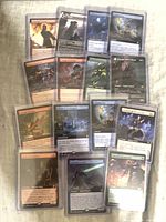 Fronts of multiple sleeved extended art MTG rares in toploaders