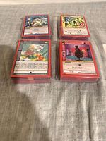 Four stacked bundles of MetaZoo cards laid out