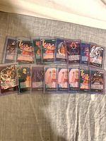 Fanned layout of fifteen sleeved leader cards