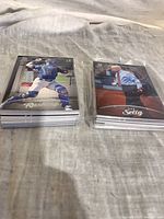 Front view of two shrink-wrapped stacks; front cards Dalton Rushing and Bud Selig.