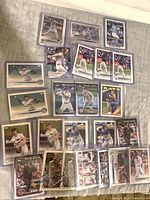 Group layout showing majority of Topps baseball cards in sleeves and top loaders