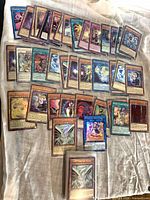 Spread of assorted sleeved Yu-Gi-Oh! foil cards laid out, showing quantity and variety
