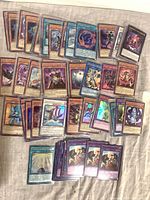 Spread of approx. 50 Yu-Gi-Oh! holo/foil cards showing various card types