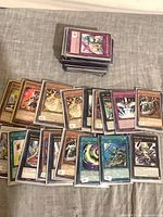 Spread of sleeved Yu-Gi-Oh! cards with additional stacked pile visible